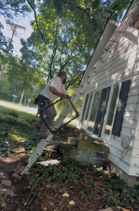 8A working off a ladder on exterior siding